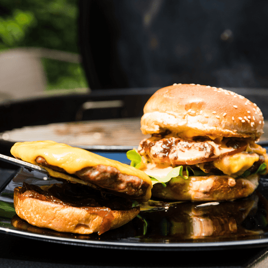 plate with a burger with toppings served off the grill