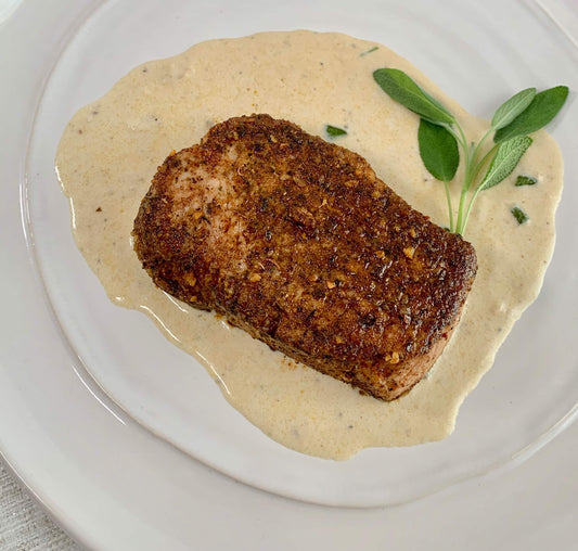 plate of pork chop sage cream sauce