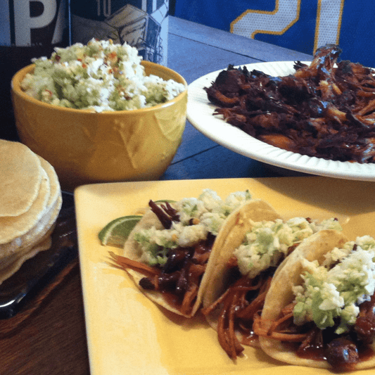 plate of Pulled Pork Tacos with slaw and a bowl of pulled pork