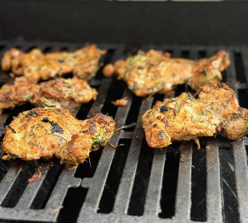 chicken thighs seasoned with latin heat on the grill