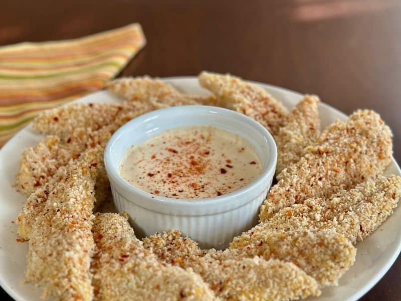 bowl of baked chicken tenders with dipping sauce